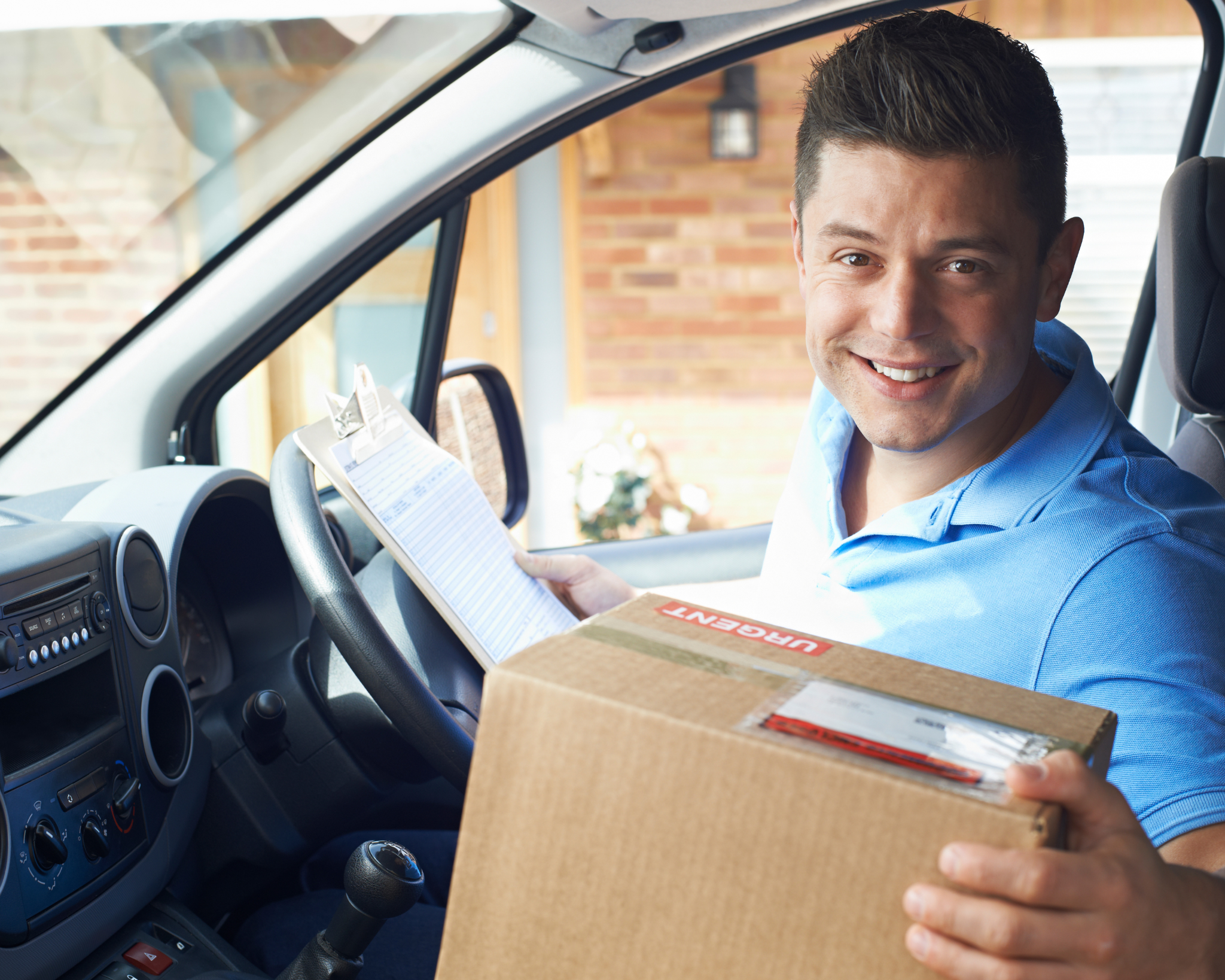 Professional courier delivering a parcel from a van